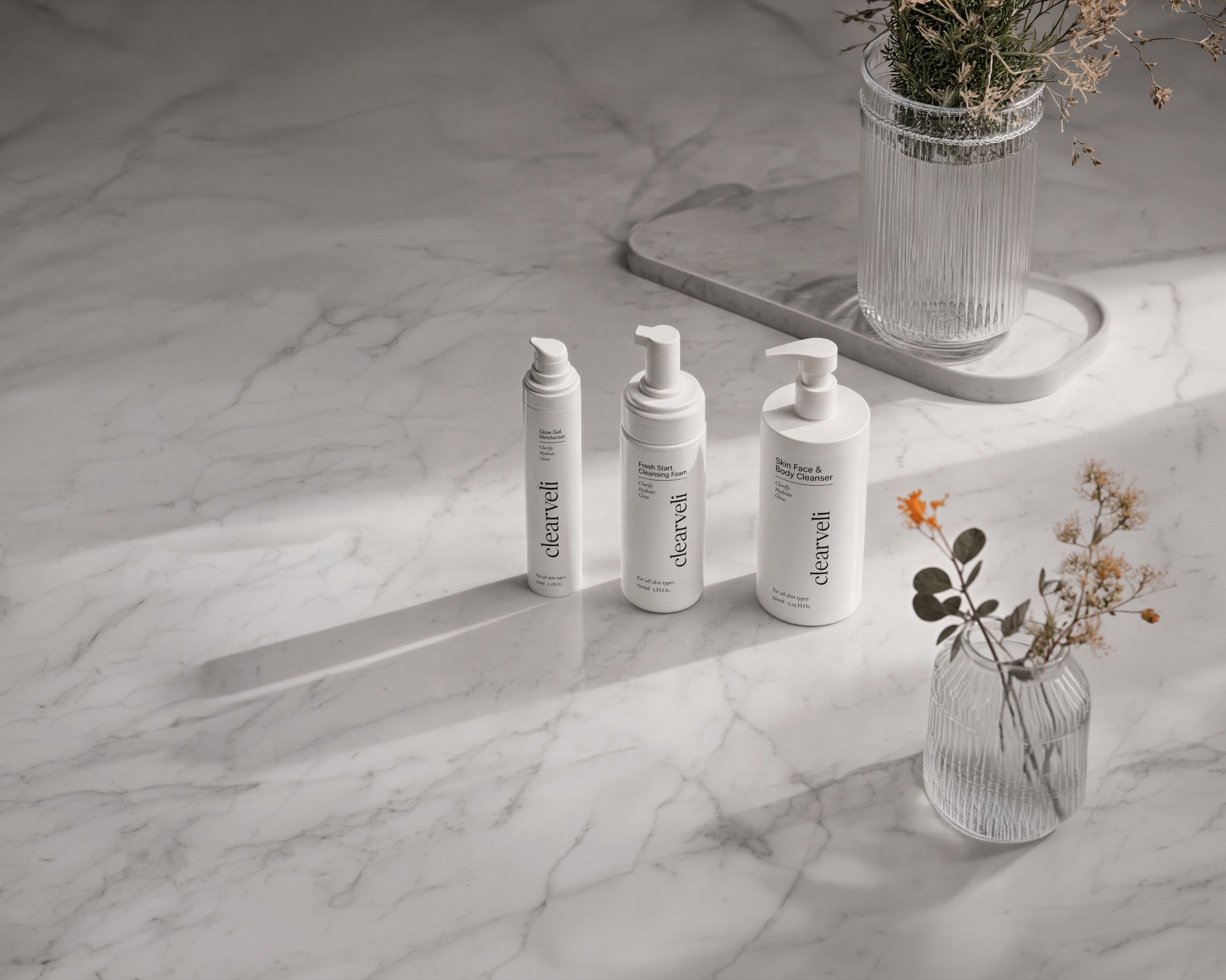 Clearveli skincare products arranged on a marble bathroom counter